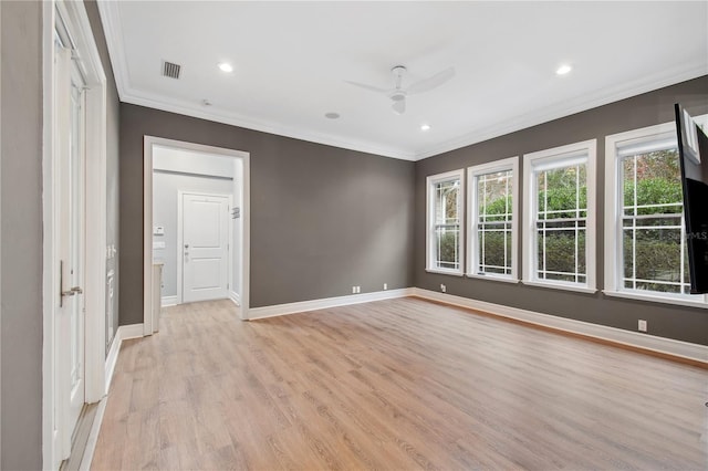 spare room featuring ceiling fan, ornamental molding, and light wood-type flooring