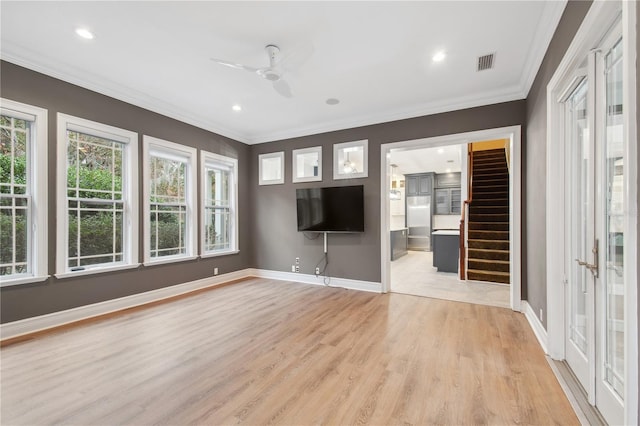 unfurnished living room with ceiling fan, crown molding, and light hardwood / wood-style flooring