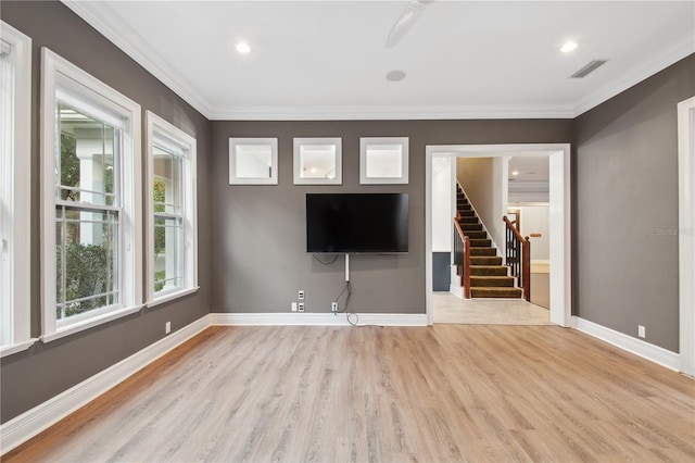 unfurnished living room with crown molding and light hardwood / wood-style flooring