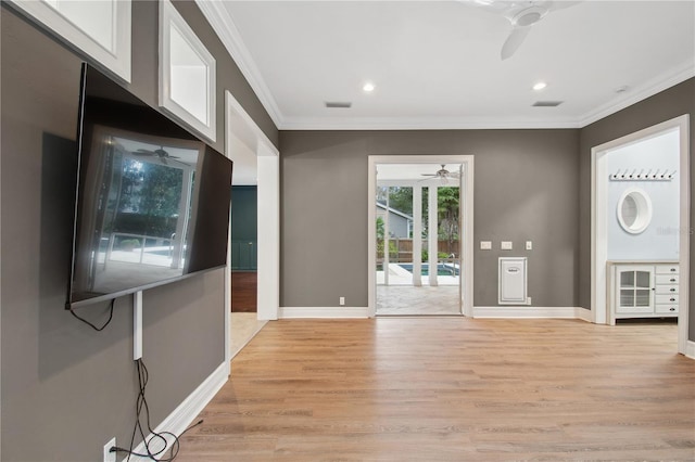 interior space featuring ceiling fan, ornamental molding, and light hardwood / wood-style flooring