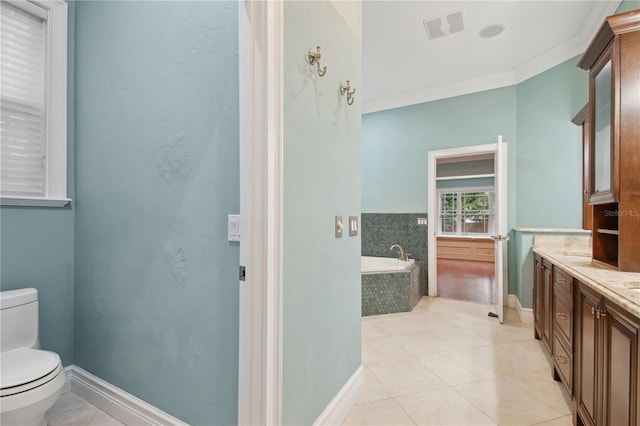 bathroom with tile patterned flooring, a relaxing tiled tub, toilet, vanity, and ornamental molding