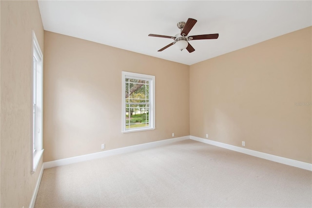 empty room with ceiling fan and light colored carpet