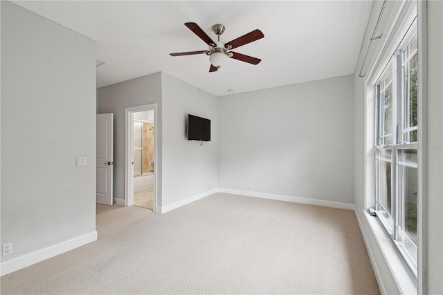 carpeted empty room with ceiling fan and a healthy amount of sunlight