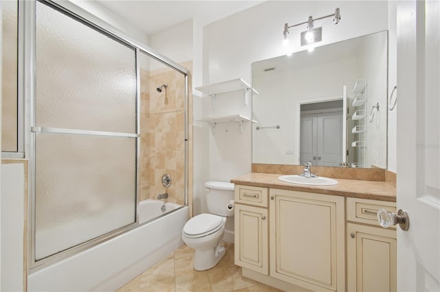 full bathroom with shower / bath combination with glass door, tile patterned floors, vanity, and toilet