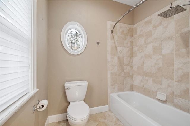 bathroom featuring toilet, tile patterned floors, and tiled shower / bath