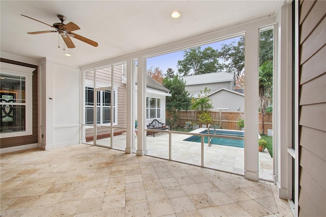 view of swimming pool featuring ceiling fan and a patio area