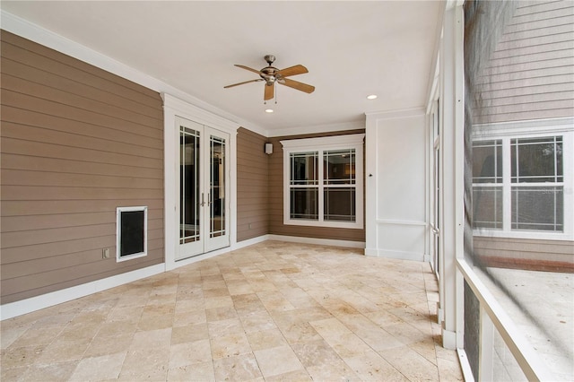 unfurnished sunroom featuring french doors and ceiling fan