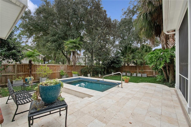 view of swimming pool with a patio area and a hot tub