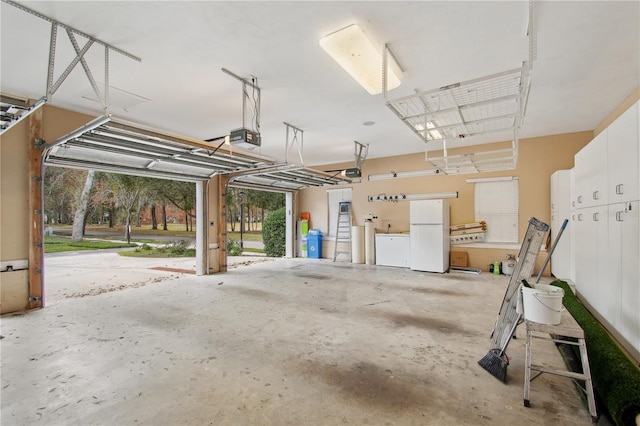 garage with white fridge and a garage door opener