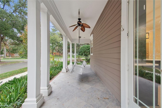 view of patio featuring ceiling fan and a porch