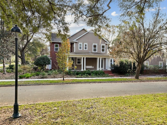 front of property featuring a front yard and a porch