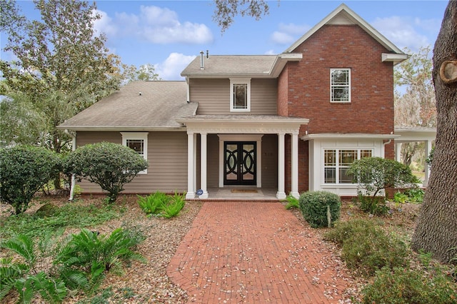 view of front property with french doors and a porch