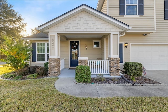 view of front of property featuring covered porch and a garage