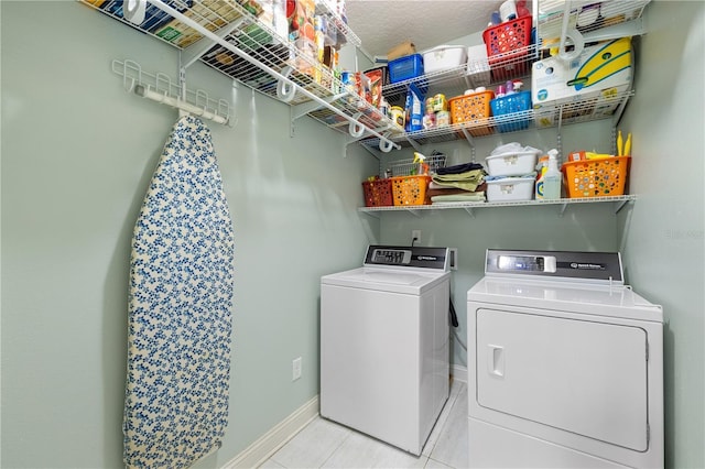 laundry room with light tile patterned floors and separate washer and dryer