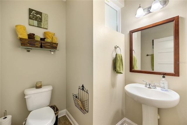 bathroom featuring sink, wood-type flooring, and toilet