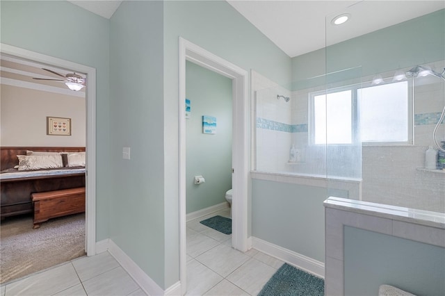 bathroom featuring a tile shower, tile patterned floors, ceiling fan, and toilet