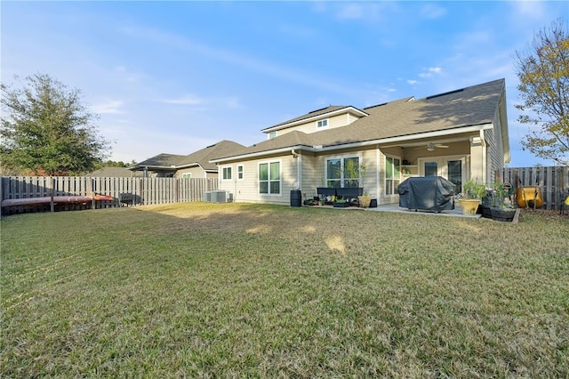 rear view of house with a lawn, central AC, ceiling fan, and a patio area