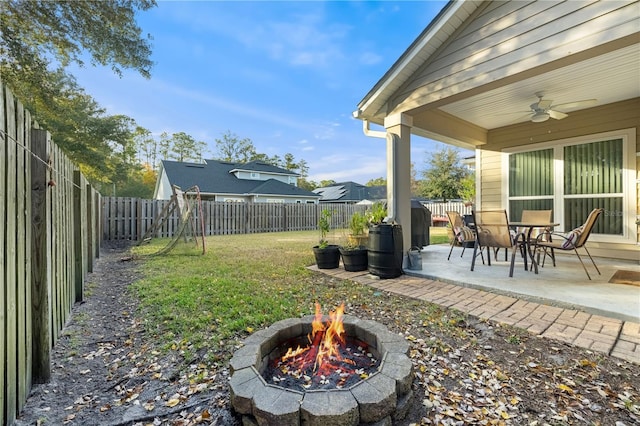 view of yard with a patio, ceiling fan, and an outdoor fire pit