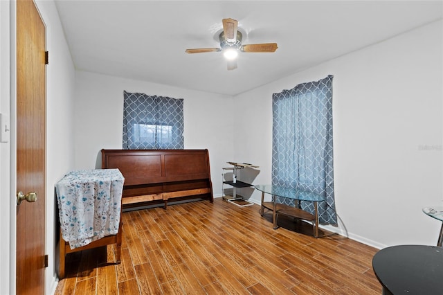 interior space featuring wood-type flooring and ceiling fan