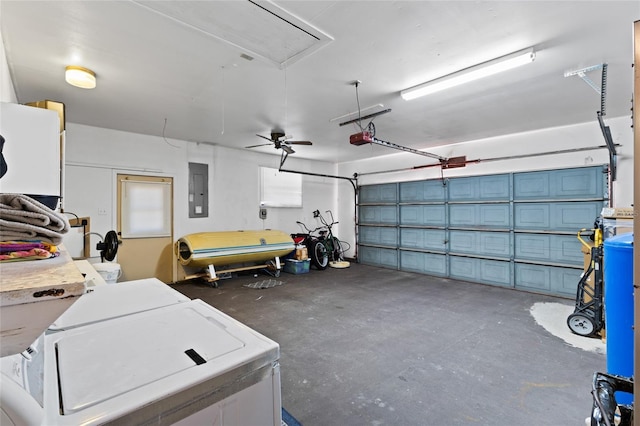 garage featuring a garage door opener, separate washer and dryer, and electric panel