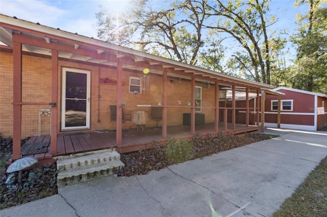 rear view of property featuring a wooden deck