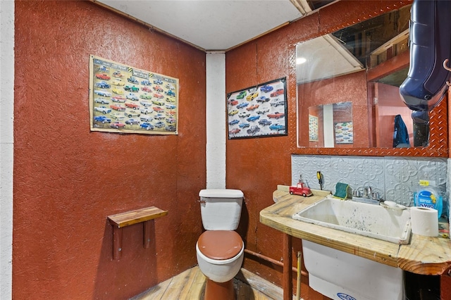 bathroom featuring hardwood / wood-style floors and toilet