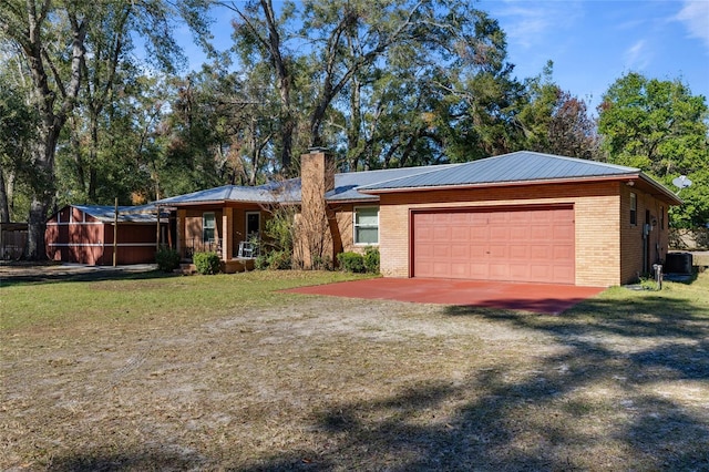 single story home featuring central AC, a garage, and a front yard