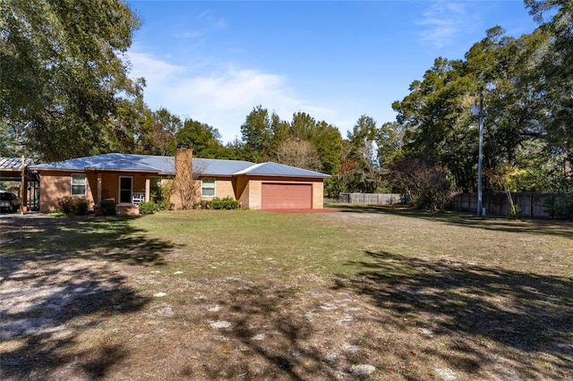 single story home featuring a garage, a front yard, and a carport