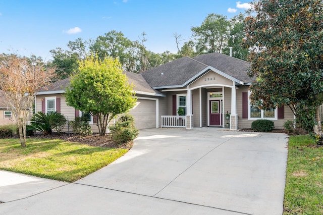 view of front of home with a front lawn, a porch, and a garage