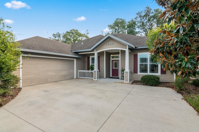 view of front of property featuring covered porch and a garage