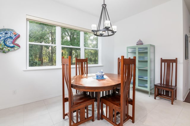 dining area with light tile patterned flooring and a chandelier