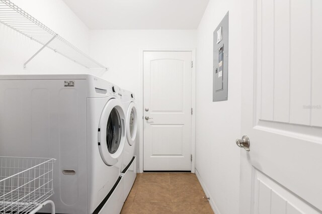 laundry area featuring light tile patterned floors and washing machine and dryer