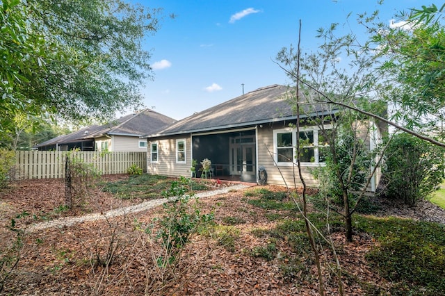 back of property with a sunroom