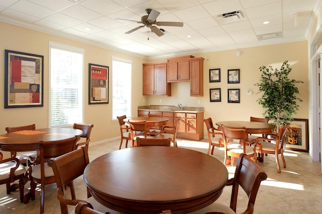 dining space featuring ornamental molding, visible vents, ceiling fan, and baseboards