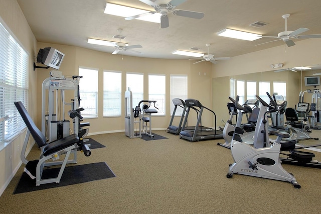 exercise room featuring carpet floors, visible vents, and baseboards