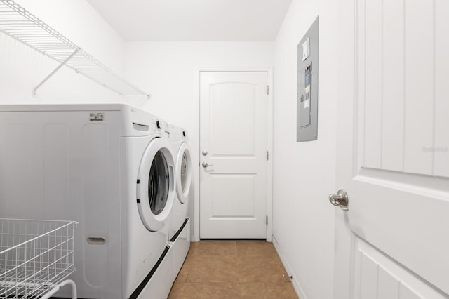 laundry room with laundry area, light tile patterned floors, baseboards, and washing machine and clothes dryer