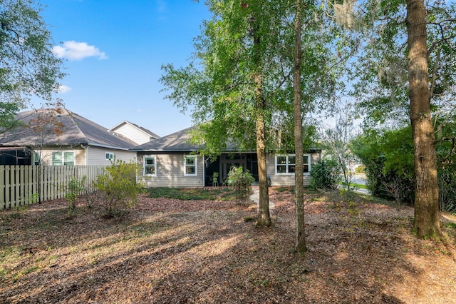 back of house featuring fence