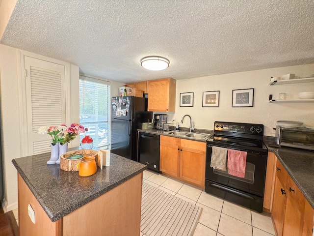 kitchen with a textured ceiling, sink, black appliances, a kitchen island, and light tile patterned flooring