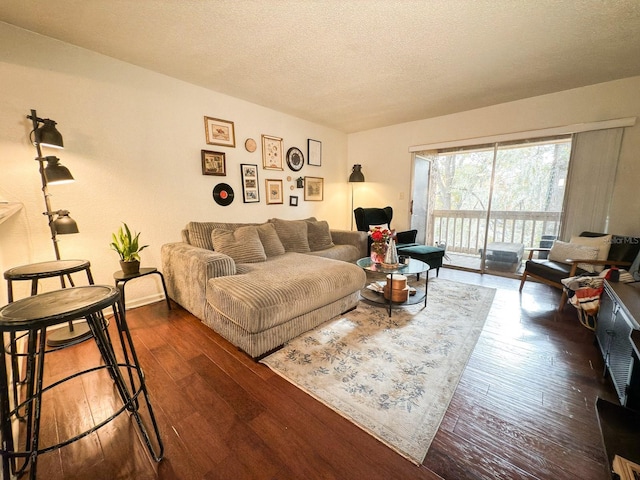 living room featuring dark hardwood / wood-style flooring and a textured ceiling