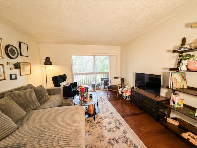 living room with dark wood-type flooring and a textured ceiling