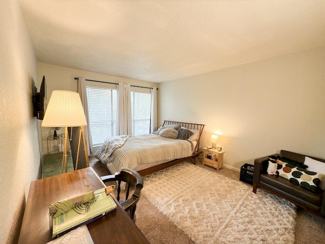 bedroom with carpet and a textured ceiling