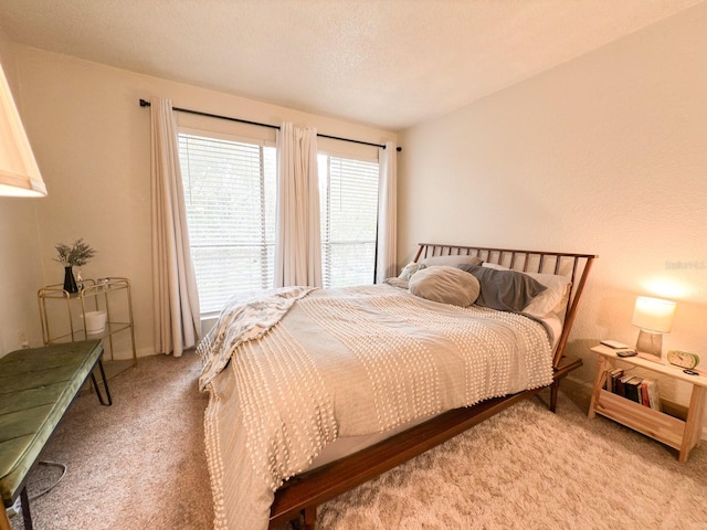 carpeted bedroom featuring a textured ceiling