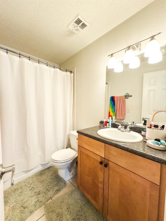 full bathroom featuring tile patterned flooring, a textured ceiling, toilet, shower / bath combo with shower curtain, and vanity