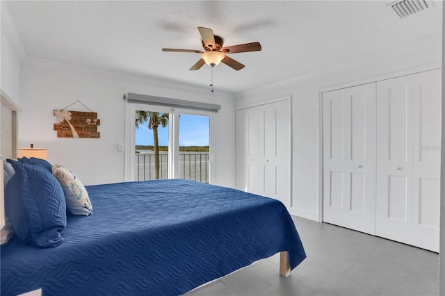 bedroom featuring a textured ceiling, two closets, access to outside, ceiling fan, and crown molding