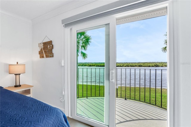 bedroom with a water view, crown molding, and multiple windows