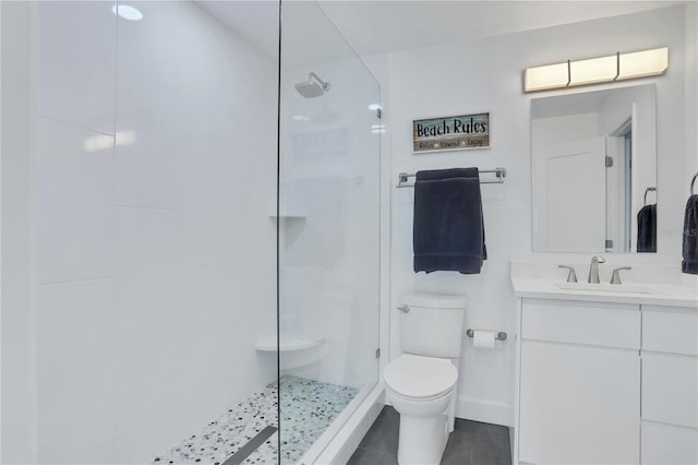 bathroom featuring tile patterned floors, vanity, toilet, and a tile shower