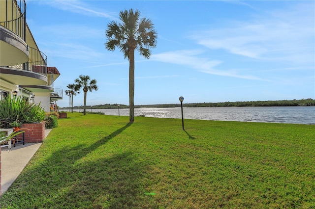 view of yard with a water view and a balcony