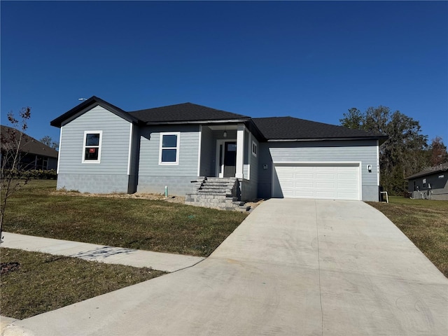 view of front of house with a garage and a front yard