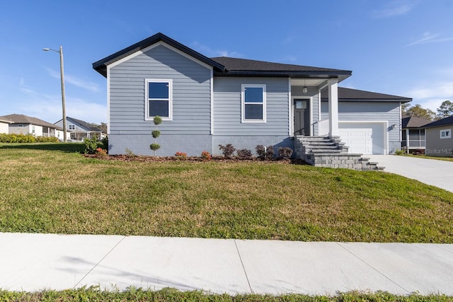 view of front facade featuring a front yard, concrete driveway, and an attached garage