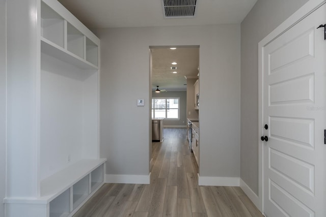 mudroom with visible vents, baseboards, light wood-style floors, and a ceiling fan